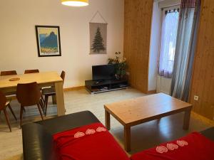a living room with a couch and a table at Val-locations la paix 7 in Le Mont-Dore
