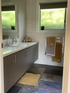 a bathroom with a sink and a window at Vista Apartment 2 in Yarra Junction