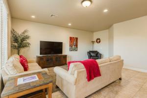 a living room with a couch and a flat screen tv at Ridge House - Two Pools Near Zion in Washington