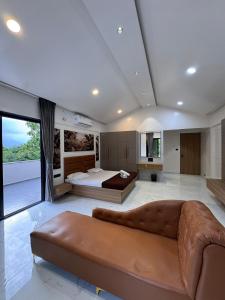 a large living room with a couch and a bed at Bhargavi Villa in Kolvan +30 photos