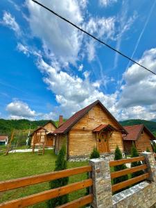 a wooden house with a fence in front of it at Vikendice Jovicic in Bukorovac