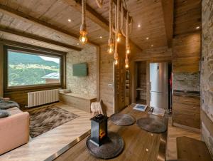 a living room with a fireplace in a wooden house at Best House snc di Elisa Baroni e Beatrice Dei Cas in Bormio