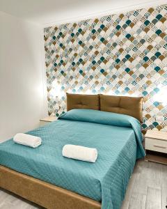 Ένα ή περισσότερα κρεβάτια σε δωμάτιο στο Costa degli Dei Rooms