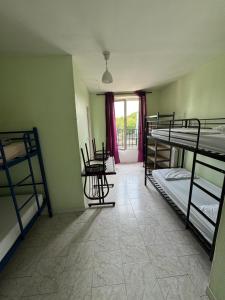 a room with several bunk beds and a table at Hostel Wilson in Saint-Denis +17 photos