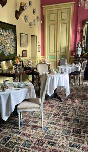 a restaurant with tables and chairs with white table cloth at Hôtel Château des Jacobins in Agen