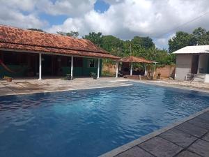 ein Swimmingpool vor einem Haus in der Unterkunft Rancho PÔR do Sol in Benevides