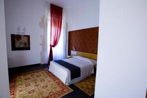 Postel nebo postele na pokoji v ubytování Grande Albergo Alfeo