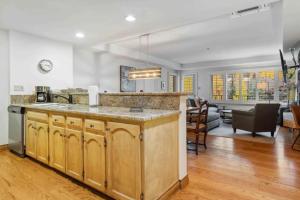 a kitchen with a counter and a living room at Lodge Tower 487 Two Bedroom Residence in Vail +15 photos