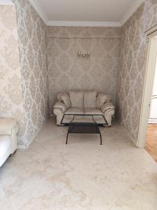 a living room with a couch and a coffee table at Liberty Square Accommodation I in Tbilisi City