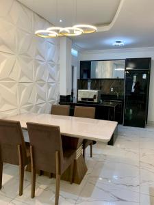 a dining room with a white table and chairs at Residência Andrade I in Manaus +15 photos