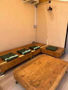 two wooden beds with green pillows in a room at Mamba Garden III in Calpe