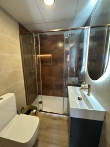 a bathroom with a shower and a toilet and a sink at Mamba Garden III in Calpe +4 photos