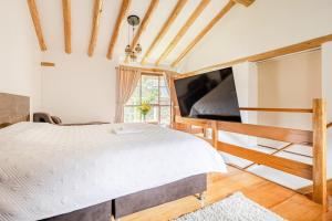a bedroom with a bed and a large tv at Hermosa casa confortable en el Valle Sagrado in Calca
