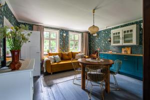 a kitchen and living room with a table and a couch at Kłodnia 1 in Rytel