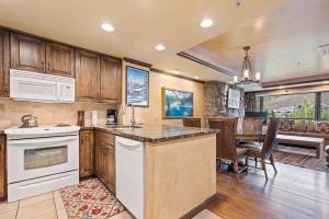 a kitchen with white appliances and a dining room at Lodge Tower 494 One Bedroom Residence in Vail