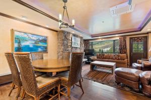 a dining room with a wooden table and chairs at Lodge Tower 494 One Bedroom Residence in Vail