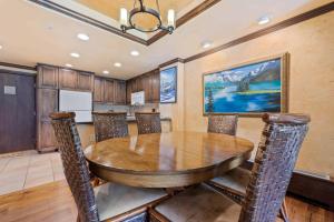 a dining room with a wooden table and chairs at Lodge Tower 494 One Bedroom Residence in Vail +12 photos