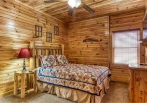 a bedroom with a bed in a log cabin at Day Dreamer Cabin W Views By Beyond Expectations in Gatlinburg