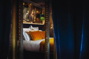 a reflection of a bed in a mirror at Madame C - Hôtel Particulier in Strasbourg