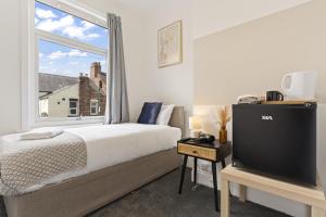a bedroom with a bed and a large window at Charlotte Street House in Redcar +20 photos