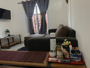 a living room with a couch and a table at Dúplex cerca del Aeropuerto y Terminal de Ómnibus in Formosa