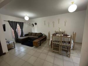 a living room with a couch and a table at Dúplex cerca del Aeropuerto y Terminal de Ómnibus in Formosa +10 photos