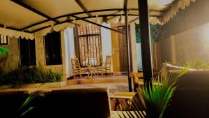 a patio with a table and chairs and an umbrella at Given House in Tuvaila