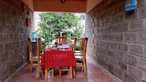 a table and chairs on a porch with a laptop on it at Given House in Tuvaila +8 photos