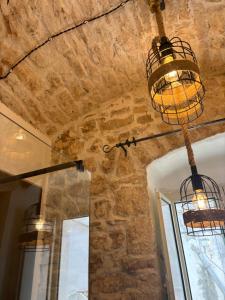 a room with two bird cages hanging from the ceiling at Dimore Levante Borgobianco in Turi +130 photos