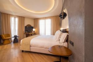 a hotel room with a bed and a table at Le Square By Onomo Collection in Casablanca +88 photos