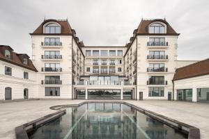 an apartment building with a pool in the courtyard at Edem Kyiv in Kozin