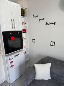 a living room with a couch and a microwave at Erdem Apart8 in Dalaman +8 photos