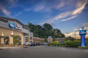 a building with a best western sign in a parking lot at Best Western Asheville-Blue Ridge Parkway in Asheville