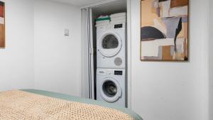 a washing machine and a washer and dryer in a room at 2 Bedroom Cozy Gem Manhattan Beach in Brooklyn