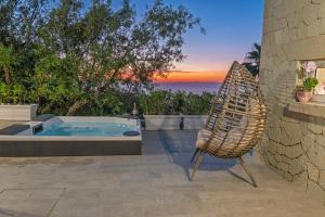 a chair sitting next to a hot tub on a patio at Maison Margot in Forio d'Ischia