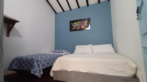 Voodi või voodid majutusasutuse CASA NOCHE AZUL alojamiento turístico toas