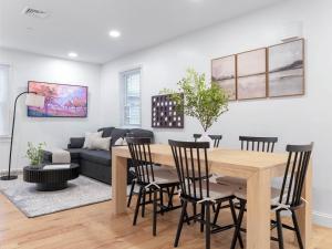 a living room with a table and chairs and a couch at 4BR 3BATH Harvard MIT Home in Cambridge