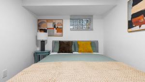 a bedroom with a bed with colorful pillows on it at 2 Bedroom Cozy Gem Manhattan Beach in Brooklyn
