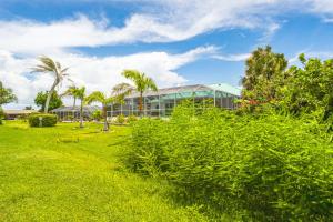 a building with palm trees in front of it at Golf Course-Facing Poolside Oasis in Rotunda West! in Rotonda West