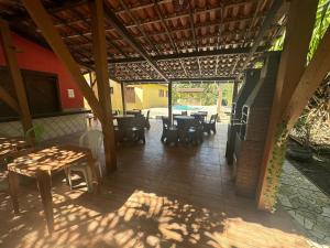 a patio with tables and chairs in a restaurant at Residencial e Pousada Ilhéus in Ilhéus