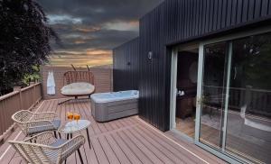 a deck with a hot tub and a table and chairs at Bellinter House Hotel & Spa in Navan +165 photos