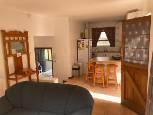 a living room with a couch and a kitchen at Jocks Place (on the sea) in Bettyʼs Bay