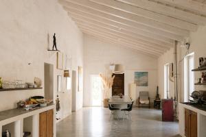 a large kitchen with white walls and wooden ceilings at Aguglia Persa - Double Room with Private Lounge in Noto +69 photos