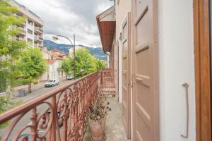 a balcony with an open door and a street at Au Petit Bonheur Proche Centre et Lac in Aix-les-Bains
