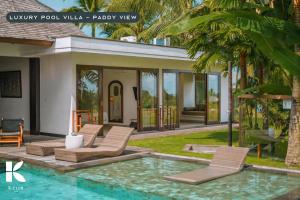 a villa with a swimming pool with a patio view at K Club Ubud in Ubud