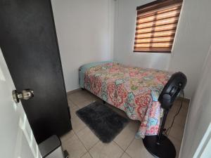 een kleine slaapkamer met een bed en een raam bij The terrazzo house in Santa Ana