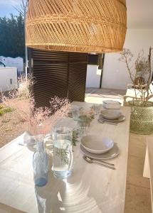 een tafel met borden en glazen erop bij Precioso retiro junto al Mar in Son Carrio