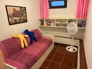 a small room with a bed and a fan at Villa Ichnos South Sardinia IUN Q8503 in Quartu Sant'Elena