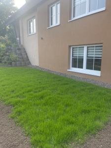 a yard in front of a house with green grass at Rosenberghof in Hillesheim