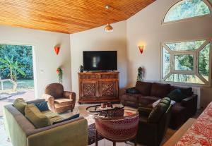 a living room with couches and a flat screen tv at Lou barede in Montagne